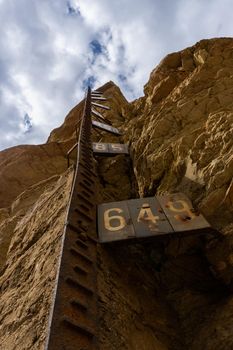 water level gauge in a swamp dried up by a severe drought storm cloudy sky