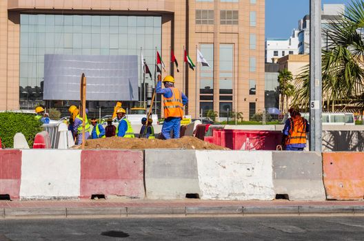 Dubai, UAE - 10.04.2021 Workers upgrading road infrastructure