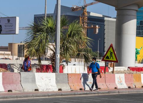 Dubai, UAE - 10.04.2021 Person on a side walk of Sheikh Zayed road