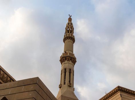 Shot of a minaret with cloudy sky on background