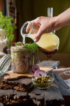 appetizer of herring with onions marinated in mustard-vinegar sauce with dill and green peas, recipe. High quality photo