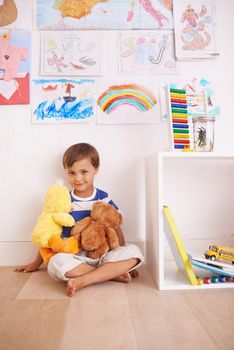 My best bear buddy. Portrait of a cute little boy playing with his stuffed animals in his room