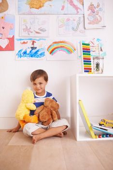 My best bear buddy. Portrait of a cute little boy playing with his stuffed animals in his room