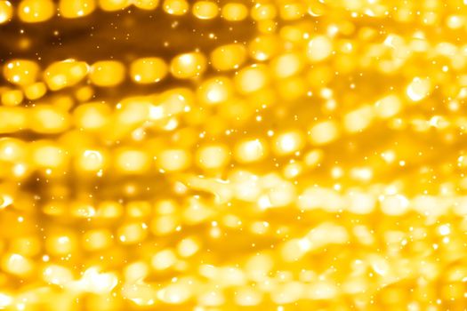 Golden Christmas lights, New Years Eve fireworks and abstract texture concept - Glamorous gold shiny glow and glitter, luxury holiday background