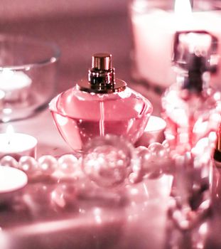 Perfumery, cosmetics branding and luxe concept - Perfume bottle and vintage fragrance on glamour vanity table at night, pearls jewellery and eau de parfum as holiday gift, luxury beauty brand present