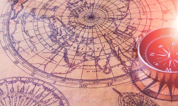 Looking for adventure. Compass and maps. Treasure map and path to the treasure. Travel and navigation. Tourist compass on the map. Travel itinerary.