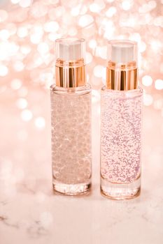 Cosmetic branding, blank label and glamour present concept - Holiday make-up base gel, serum emulsion, lotion bottle and rose gold glitter, luxury skin and body care cosmetics for beauty brand ads