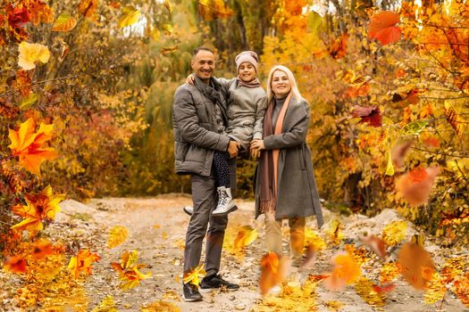 Family playing in autumn park having fun. High quality photo