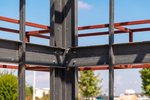 Structural steel beam connections, metal column supporting the roof construction. Structural steel concept