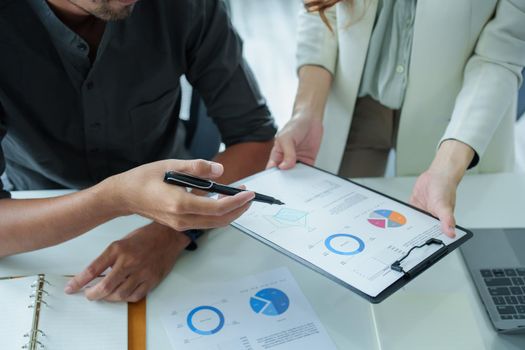 A portrait of a female marketer and a male salesperson discussing how to increase sales by investing in new products to expand marketing using documents and computers in working, new idea product.