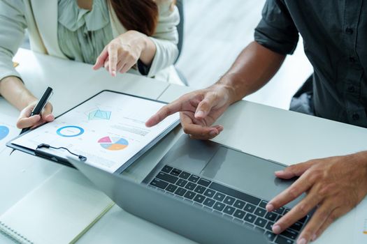 A portrait of a female marketer and a male salesperson discussing how to increase sales by investing in new products to expand marketing using documents and computers in working, new idea product.