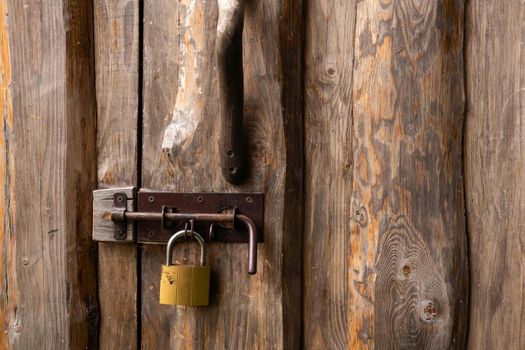 Old padlock on a wooden door.