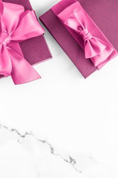 Birthday, wedding and girly branding concept - Pink gift box with silk bow on marble background, girl baby shower present and glamour fashion gift for luxury beauty brand, holiday flatlay art design