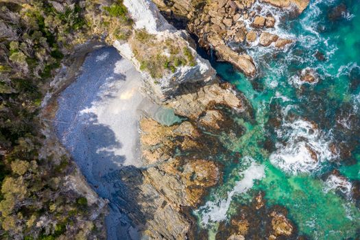 Aerial coastal views of rocky inlets, caves and hidden beaches