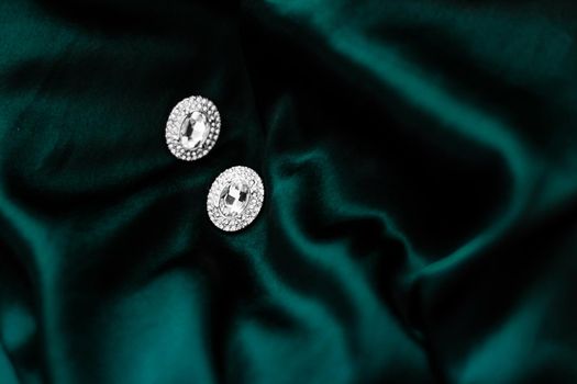 Jewellery brand, elegant fashion and bridal luxe gift concept - Luxury diamond earrings on dark emerald green silk, holiday glamour jewelery present