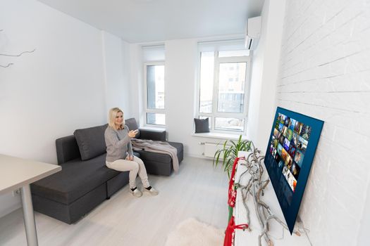 Happy woman watching TV, Christmas