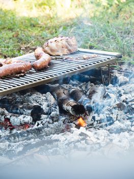 cooking pork meat in the grill outdoors with charcoal