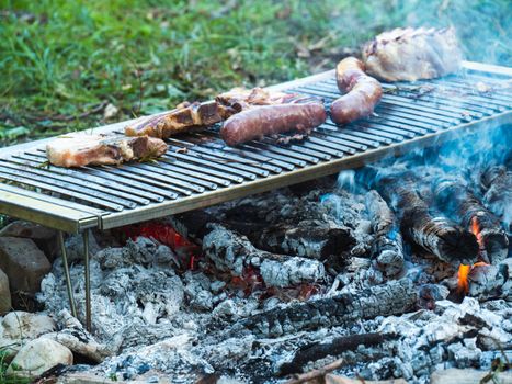 cooking pork meat in the grill outdoors with charcoal
