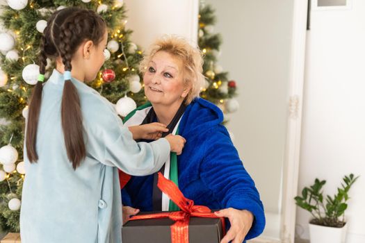 grandmother and granddaughter christmas with flag of united arab emirates at christmas.