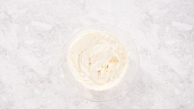 Flat lay. Step by step. Preparing store-bought buttercream frosting to make unicorn rainbow chocolate cupcakes.