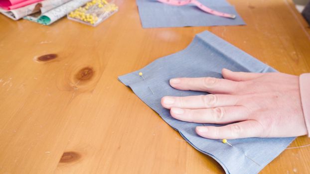 Sewing cotton face mask with a sewing machine for coronavirus outbreak.