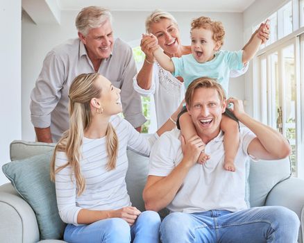 Children, family and baby with grandparents, a child and his parents during a visit while sitting on a sofa in a living room. Kids, happy and smile with a senior man and woman at home with relatives.