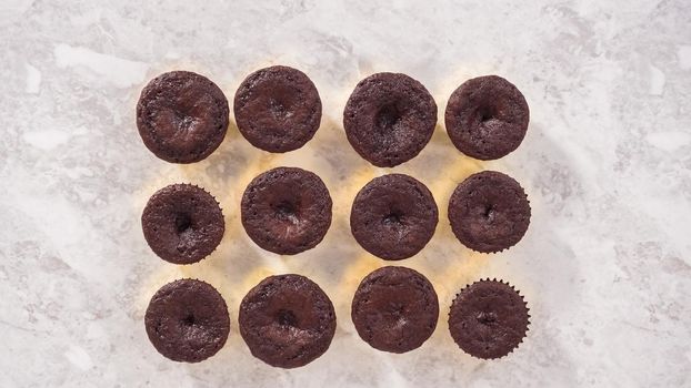 Flat lay. Step by step. Cooling freshly baked chocolate cupcakes to be decorated with buttercream frosting.