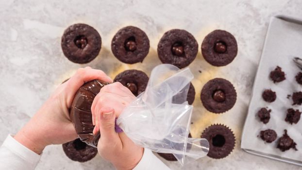 Flat lay. Step by step. Filling in chocolate cupcakes with chocolate ganache.