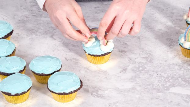 Step by step. Decorating chocolate cupcakes with buttercream frosting and rainbow candy.