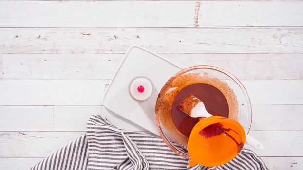 Flat lay. Preparing homemade chocolate ganache for chocolate raspberry cupcakes.