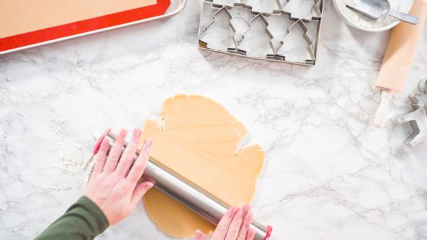 Flat lay. Step by step. Rolling out sugar cookie dough to bake Christmas cookies.
