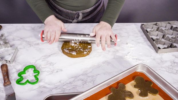 Step by step. Rolling out gingerbread cookie dough to bake Christmas cookies.