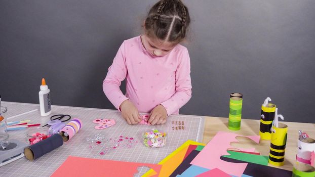 Kids papercraft. Making paper bugs out of the empty toilet paper rolls and construction paper.