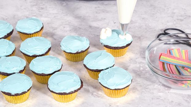 Step by step. Decorating chocolate cupcakes with buttercream frosting and rainbow candy.