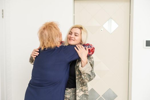 Soldier woman reunited with her mother.