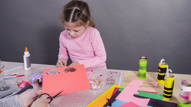 Kids papercraft. Making paper bugs out of the empty toilet paper rolls and construction paper.