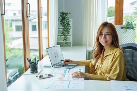 Portrait of a business woman, accountant, marketer, showing a smiling face during the start of a new morning before working.