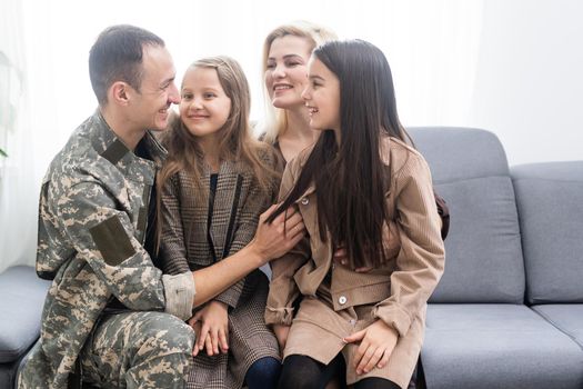 Family Greeting Military Father Home On Leave.