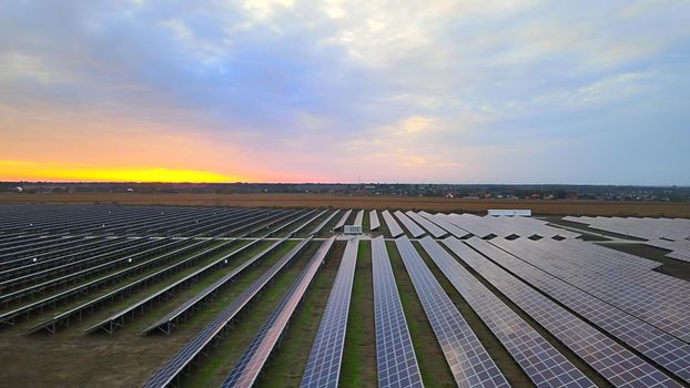 Large solar panels at a solar farm at summer sunset. Solar cell power plants. footage HDR video 4k, aerial drone view