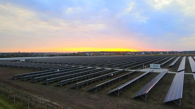 Large solar panels at a solar farm at summer sunset. Solar cell power plants. footage HDR video 4k, aerial drone view