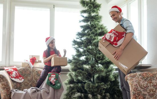 Happy father and young daughter decorate the Christmas tree at home, morning before Xmas, Merry Christmas and Happy Holiday Concept