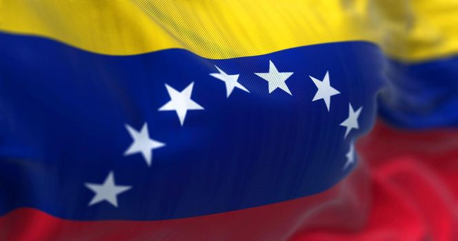 Close-up view of Venezuela national flag waving in the wind. The Bolivarian Republic of Venezuela is a country on the northern coast of South America. Fabric textured background. Selective focus