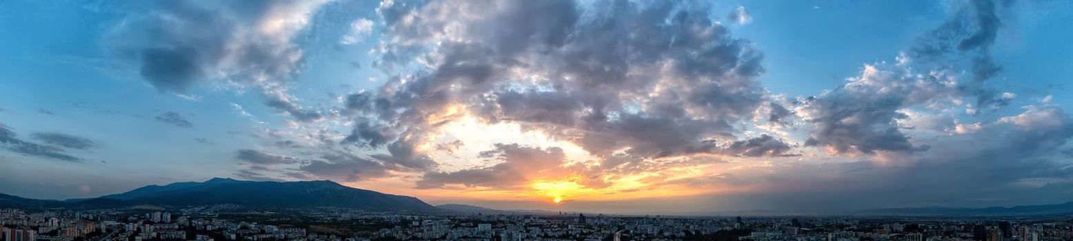 Dramatic clouds and sun in the sky at sunset