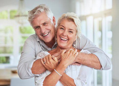 Love, couple and retirement with a senior man and woman looking happy and hugging in their home together. Smile, romance and relationship with an elderly male and female pensioner in a house.