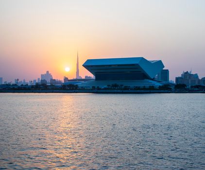 Sunset at Dubai Festival city. New building of Sheikh Muhammad Bin Rashid library on the scene as well as tallest building in the world Burj Khalifa on background. Outdoors