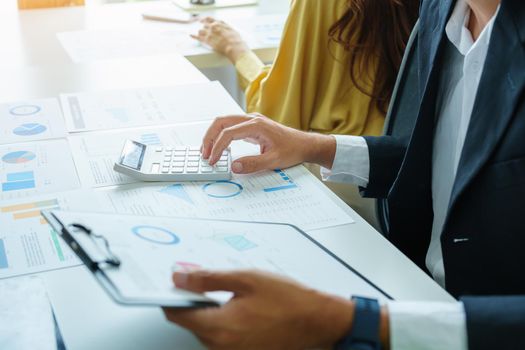 A male businessman or accountant is using the current year profitable investment budget calculator to calculate the IRS.