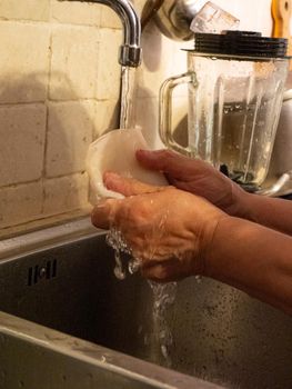 cleaning a raw adriatic cuttlefish at home in Numana, Marche, Italy