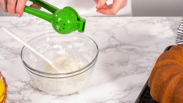 Step by step. Mixing ingredients in a glass mixing bowl to prepare lemon glaze for a lemon bundt cake.