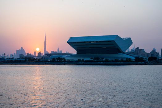 Sunset at Dubai Festival city. New building of Sheikh Muhammad Bin Rashid library on the scene as well as tallest building in the world Burj Khalifa on background. Outdoors