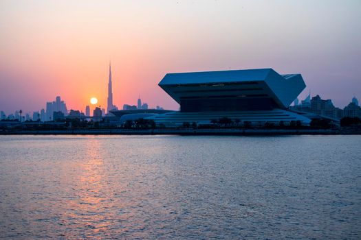 Sunset at Dubai Festival city. New building of Sheikh Muhammad Bin Rashid library on the scene as well as tallest building in the world Burj Khalifa on background. Outdoors